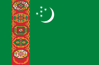 The flag of Turkmenistan has a green field. It features a red vertical band, bearing five carpet guls stacked above two crossed olive branches, near the hoist end of the field. Just to the fly side of the vertical band near the top edge of the field is a hoist-side facing white crescent and five small five-pointed white stars placed just outside the crescent opening.